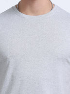 close view of man wearing t-shirt whose colour is Grey Melange .
