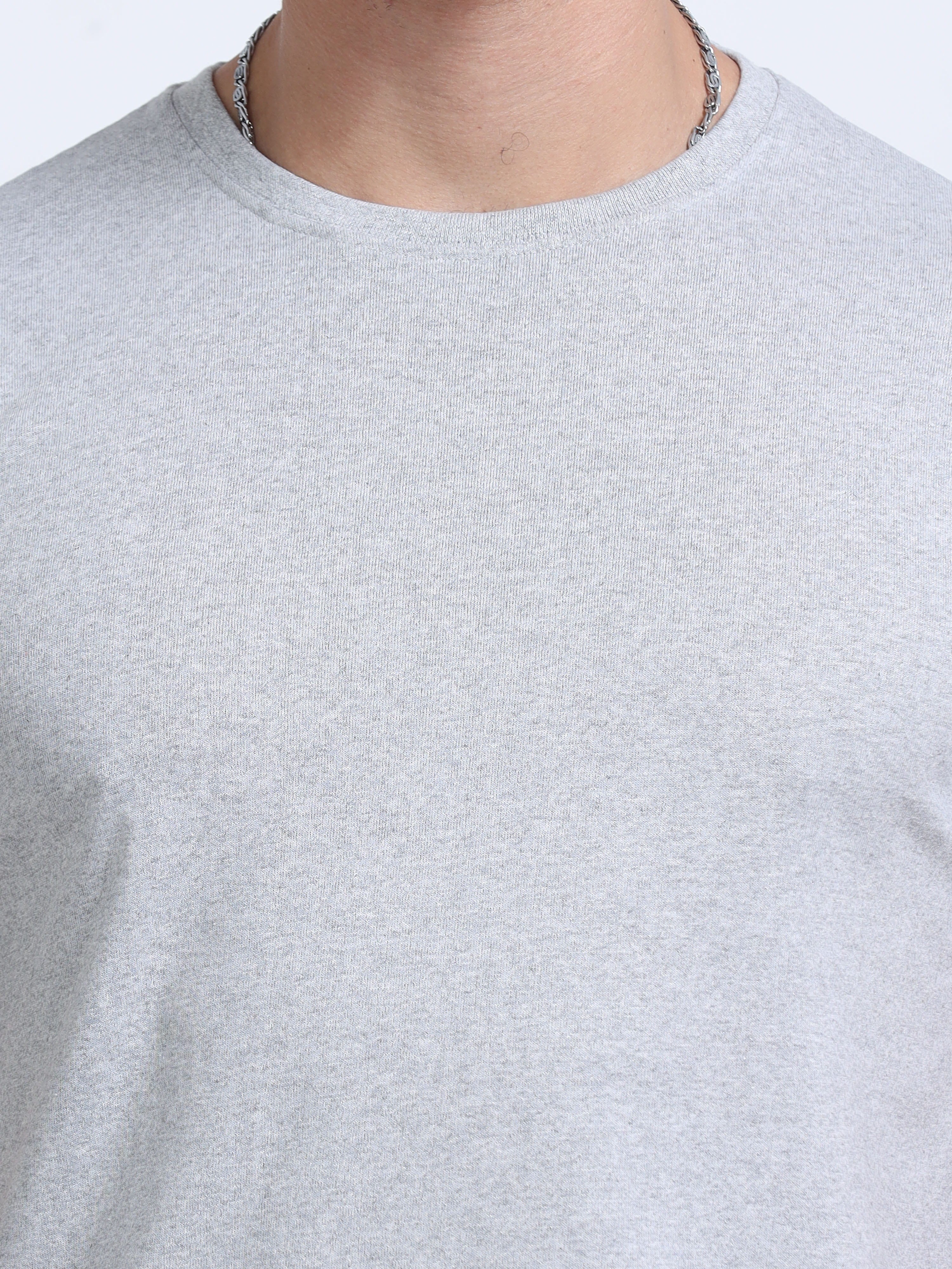 close view of man wearing t-shirt whose colour is Grey Melange .