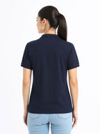 back view of women Wearing  organic cotton polo t-shirt navy blue