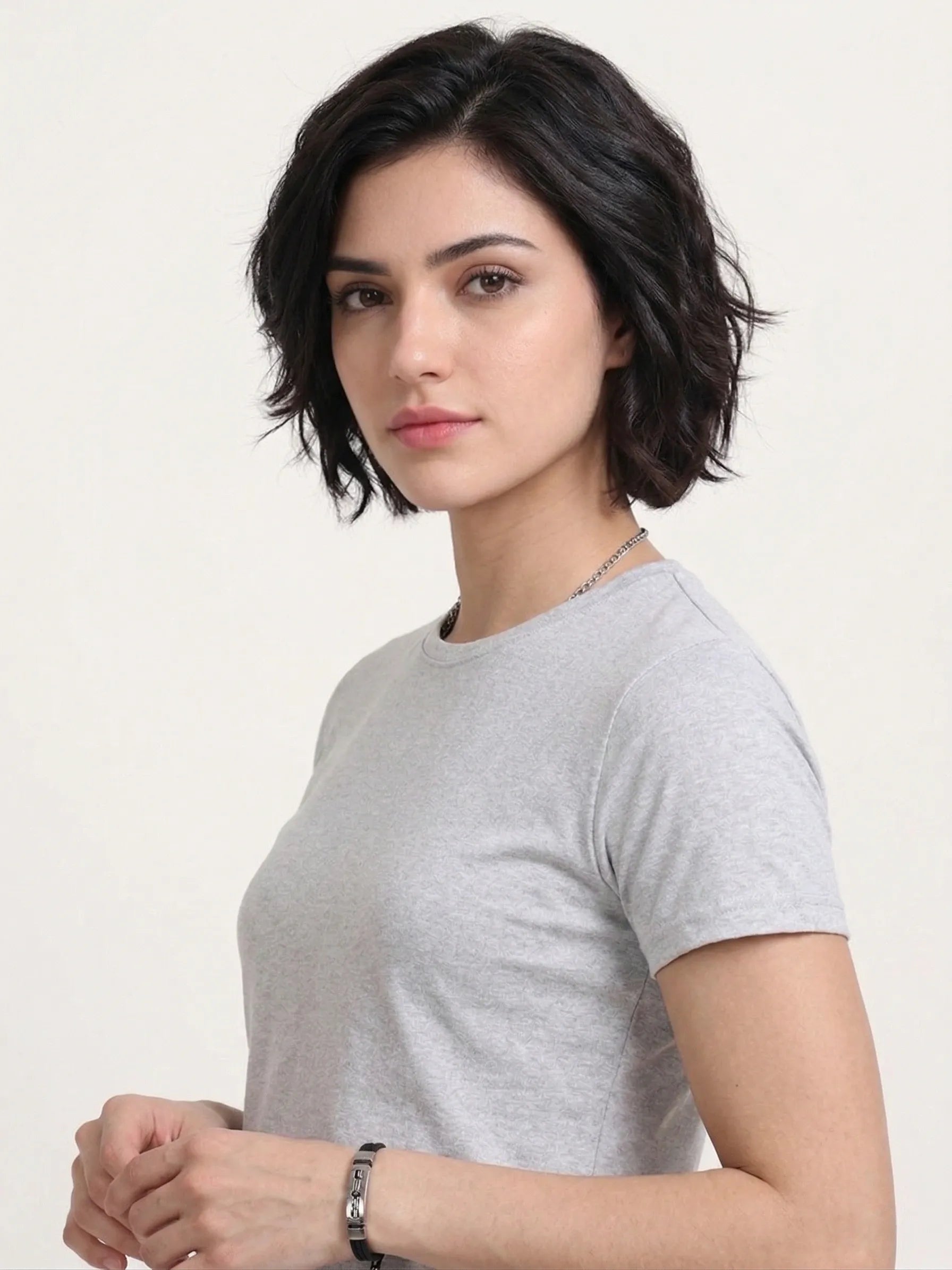side view of woman wearing t-shirt whose colour is Grey Melange .