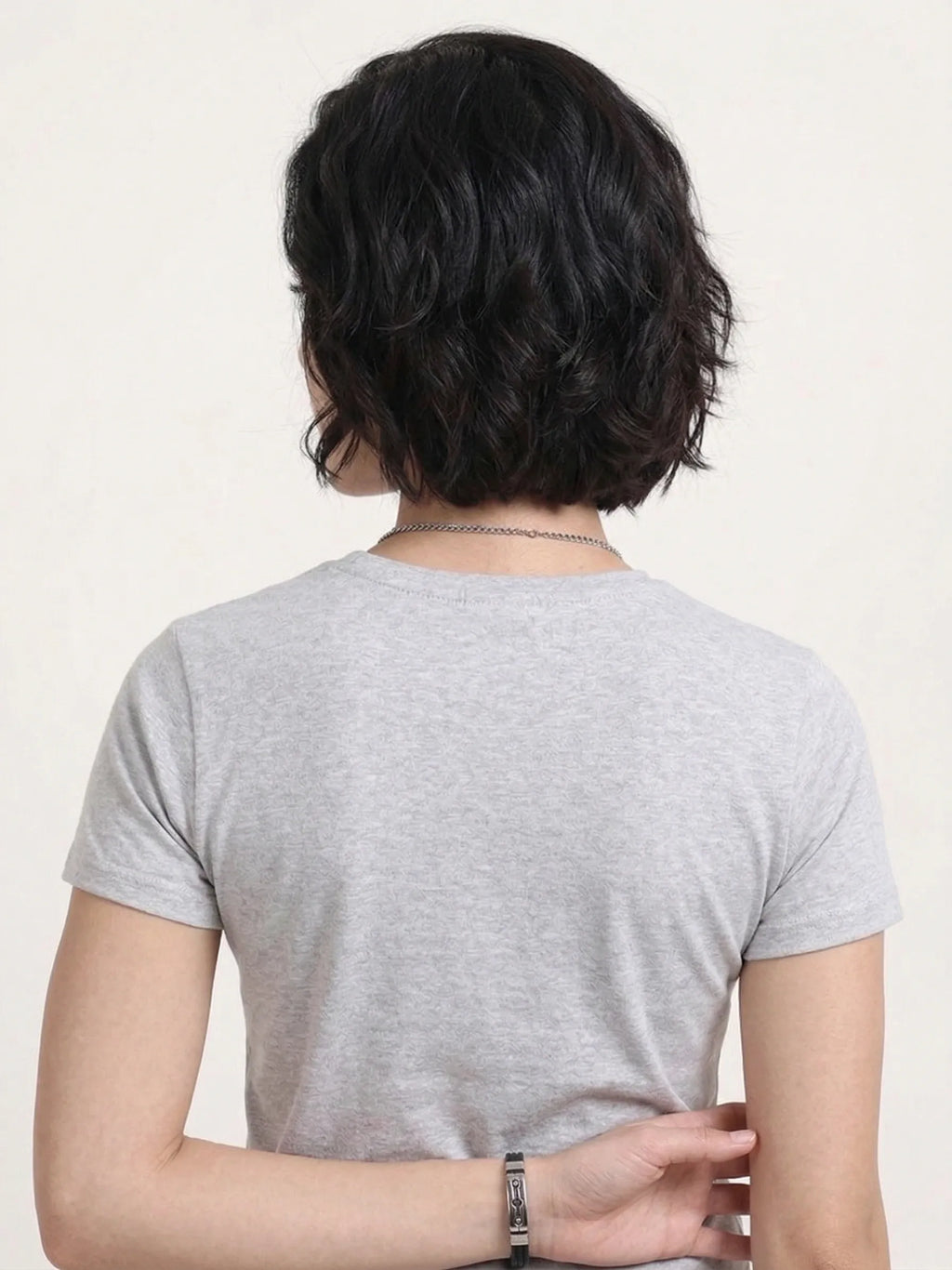 back view of woman wearing t-shirt whose colour is Grey Melange .