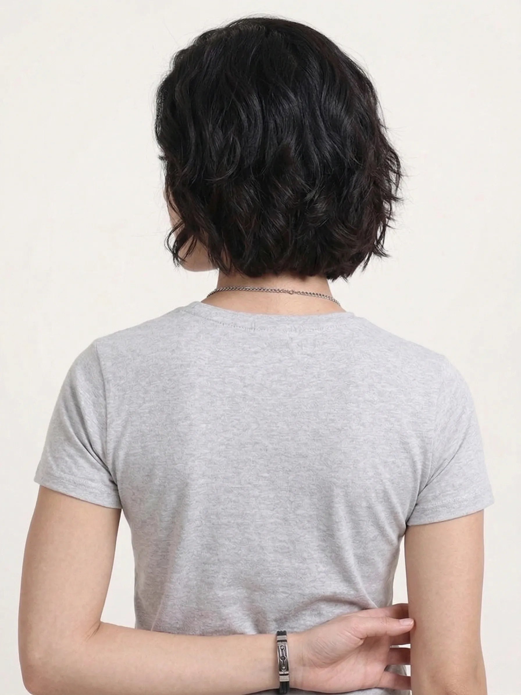 back view of woman wearing t-shirt whose colour is Grey Melange .