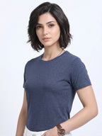 side view of woman wearing t-shirt whose colour is Navy Melange
