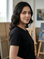 Woman in a black t-shirt standing in an indoor setting