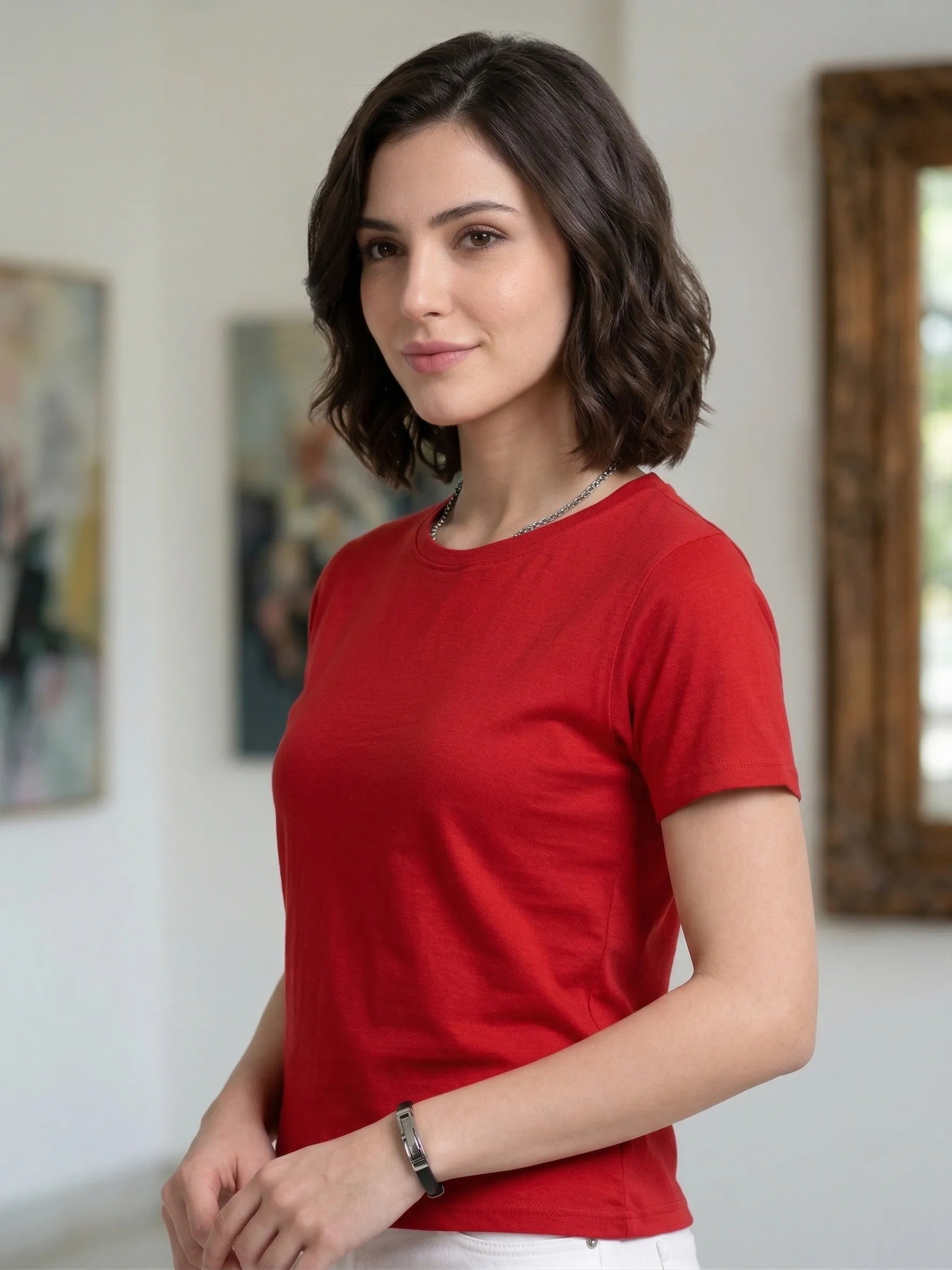 Woman wearing a red t-shirt in an indoor setting