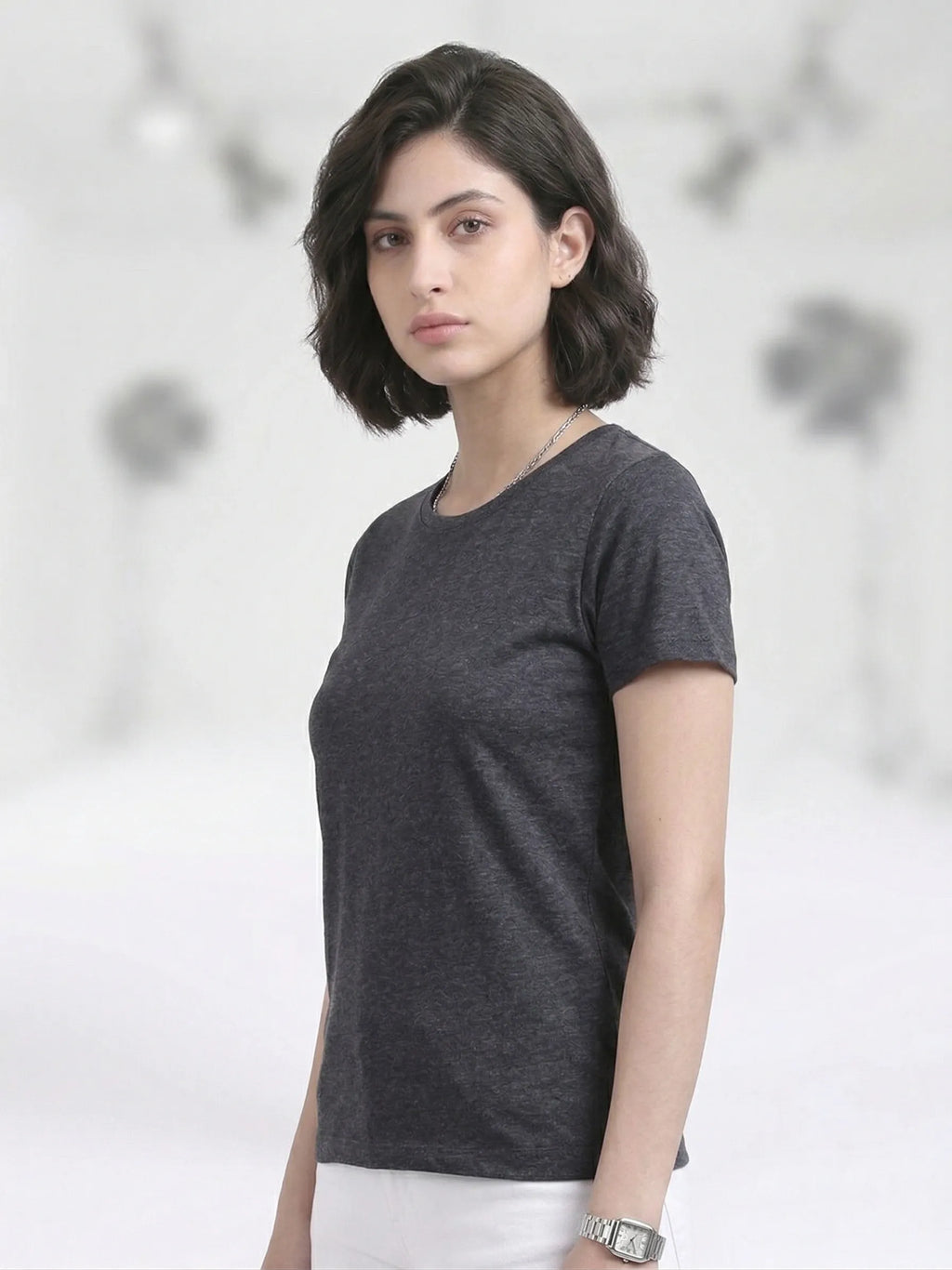 semi front view of woman wearing t-shirt whose colour is Charcoal 